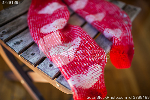 Image of Red socks with heart pattern on wooden chair