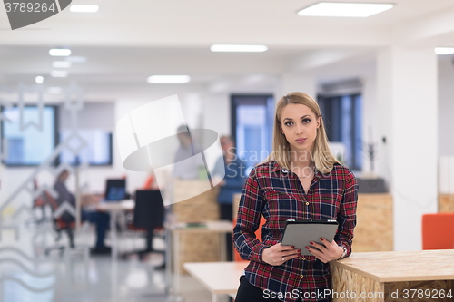 Image of portrait of young business woman at office with team in backgrou