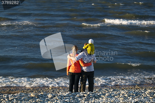 Image of Young family enjoying a day at the seaside