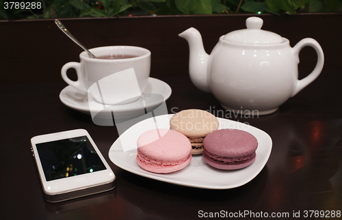 Image of Tea and macaroons with a tablet computer