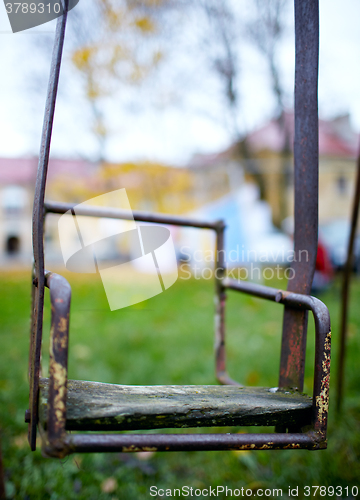 Image of The broken child\'s swing.