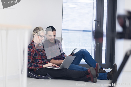 Image of startup business, couple working on laptop computer at office
