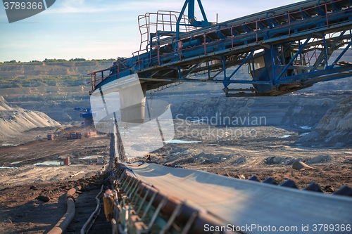 Image of Long conveyor belt transporting ore