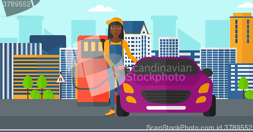 Image of Woman filling up fuel into car.