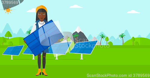 Image of Woman holding solar panel.