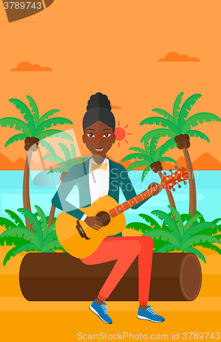 Image of Woman playing guitar.