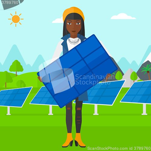 Image of Woman holding solar panel.