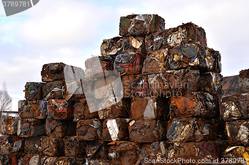 Image of A pile of compressed cars in blocks for processing