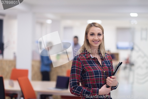 Image of portrait of young business woman at office with team in backgrou