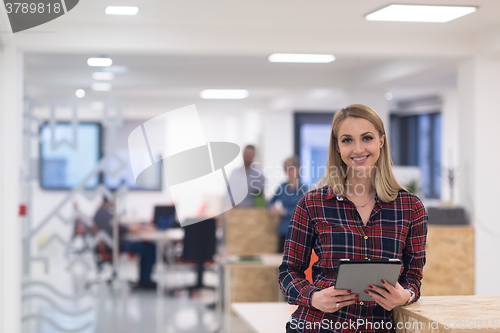 Image of portrait of young business woman at office with team in backgrou