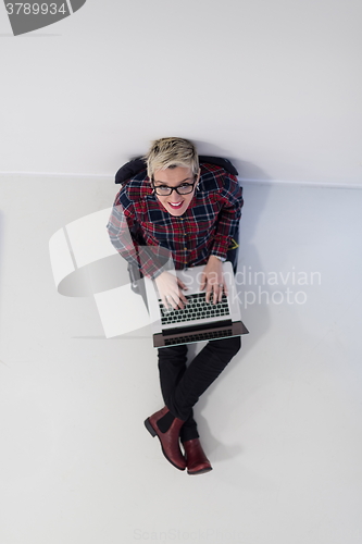 Image of top view of young business woman working on laptop computer