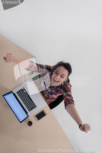 Image of top view of young business woman working on laptop