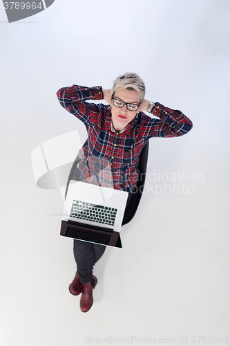 Image of top view of young business woman working on laptop computer