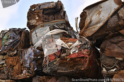 Image of A pile of compressed cars in blocks for processing