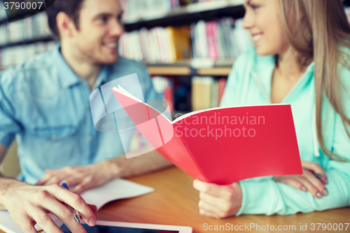 Image of close up of students with notebooks in library