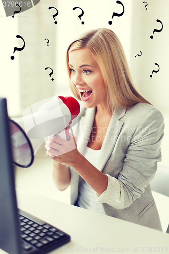 Image of crazy businesswoman shouting in megaphone
