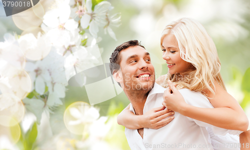 Image of happy couple over cherry blossoms background