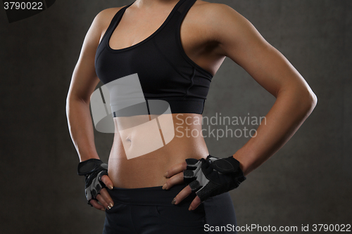 Image of close up of young woman body in gym