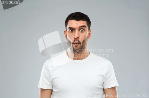 Image of man with fish-face over gray background