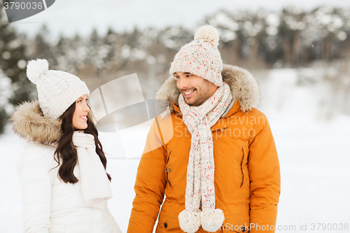 Image of happy couple walking over winter background