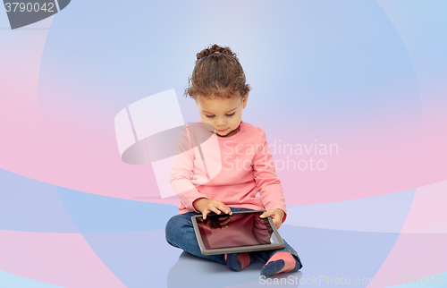 Image of little baby girl playing with tablet pc computer