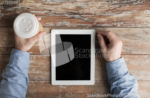 Image of close up of male hands with tablet pc and coffee