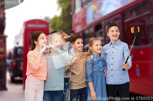 Image of kids taking selfie by smartphone over london city