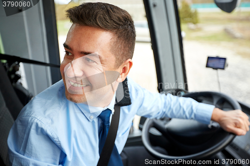 Image of happy driver driving intercity bus