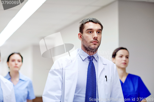 Image of group of medics walking along hospital