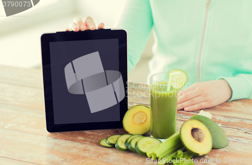 Image of close up of woman with tablet pc and vegetables