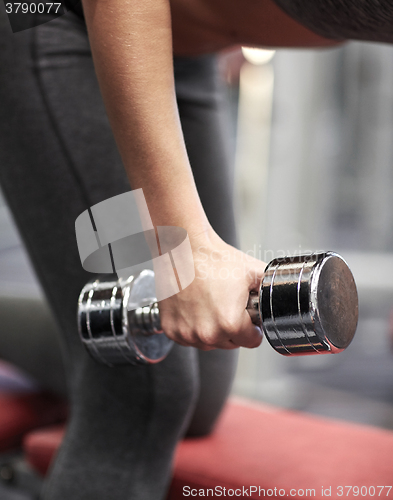 Image of close up of couple with dumbbell exercising in gym