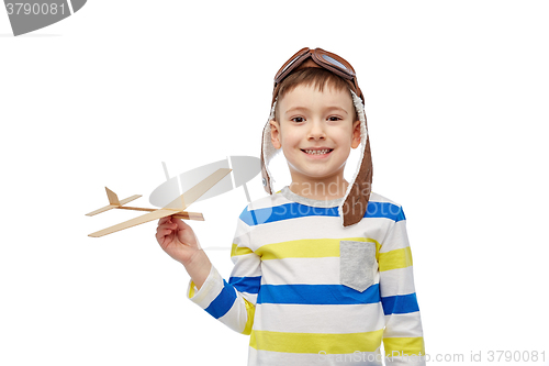 Image of happy little boy in aviator hat with airplane