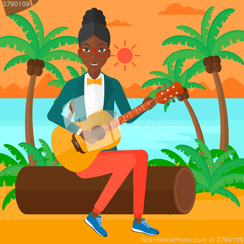 Image of Woman playing guitar.