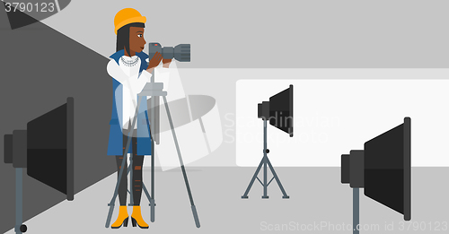 Image of Photographer working with camera on a tripod.