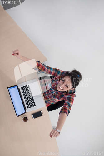 Image of top view of young business woman working on laptop