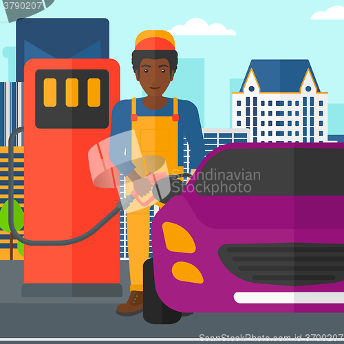 Image of Man filling up fuel into car.