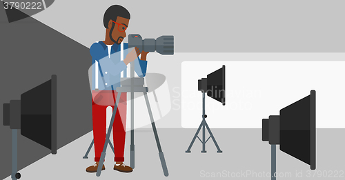 Image of Photographer working with camera on a tripod.
