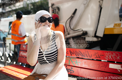 Image of Young woman talking on the phone