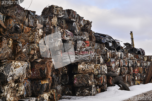 Image of A pile of compressed cars in blocks for processing