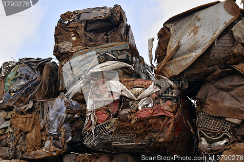 Image of A pile of compressed cars in blocks for processing