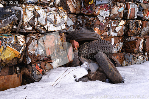 Image of A pile of compressed cars in blocks for processing