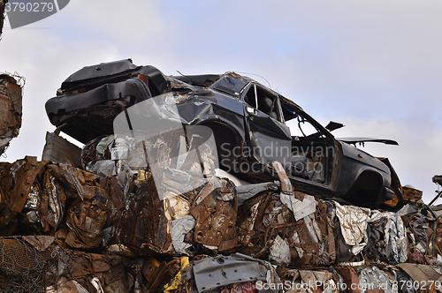 Image of A pile of compressed cars in blocks for processing