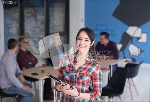 Image of portrait of young business woman at office with team in backgrou