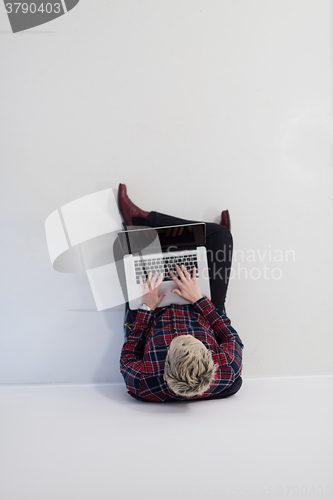 Image of top view of young business woman working on laptop computer