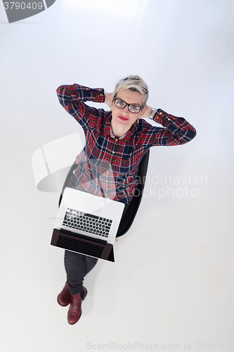 Image of top view of young business woman working on laptop computer