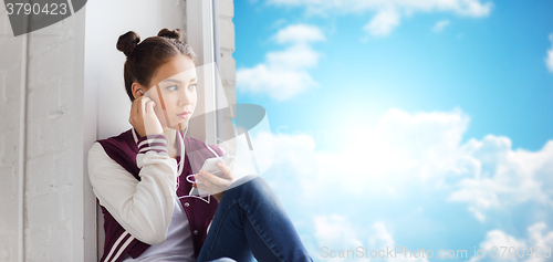 Image of teenage girl with smartphone and earphones