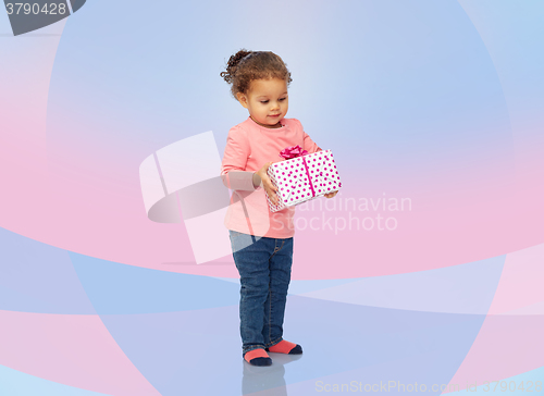 Image of beautiful little baby girl with birthday present