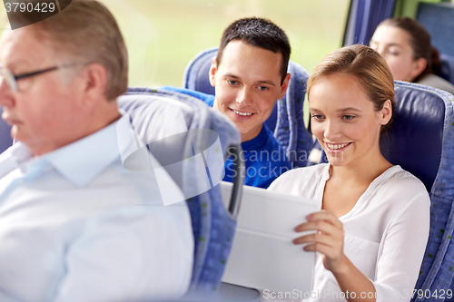 Image of happy couple with tablet pc in travel bus