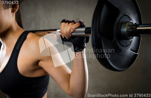 Image of close up of woman with barbell in gym