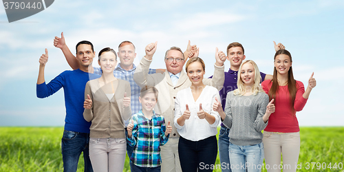Image of group of smiling people showing thumbs up